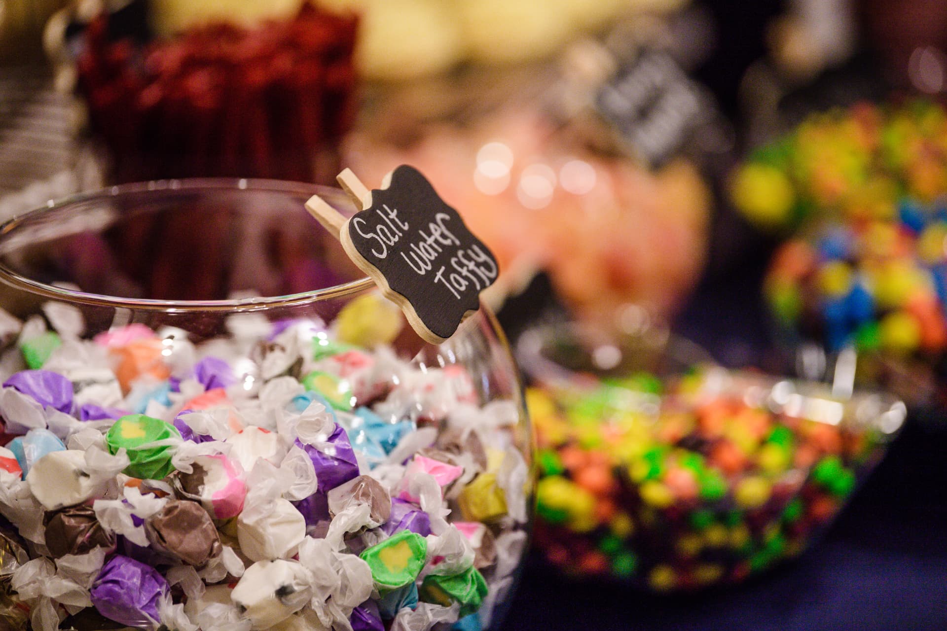 Close-up of salt water taffy and colourful candy jars at a Calgary wedding candy bar