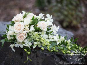 Banff Wedding Florist - Cascading white bouquet with greenery; Wedding Flowers With Love By Fiori Con Amore; Banff Wedding Planner - Creative Weddings Planning & Decor; Rimrock Resort Wedding; Eric Daigle Photography